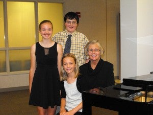 Three private music students of Sharon Astrup-Scott shared their talent at 12:30 p.m. June 26 at the Mayo Clinic Health System rotunda. Pictured are Michael Blong, back, Cali Mowens, left, Elise Grzybowski and Astrup-Scott. Students performed authentic pieces by Bach, Grieg, Padereski, 20th century and contemporary composers. All were vocal, piano and violin. Astrup-Scott teaches beginner through advanced students. --Submitted