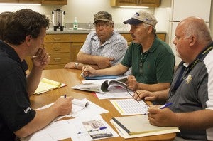 Nunda Township Supervisor Curt Honsey, back middle, and Chairman Scott Marpe speak with officials from the Minnesota Homeland Security and Emergency division and the Federal Emergency Management Agency Thursday about damages from storms June 20-26. 