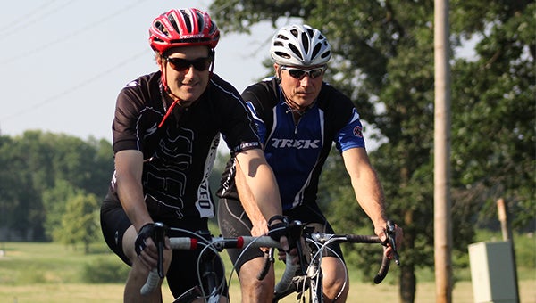James Cope, left, rides his Specialized Roubaix road bike next to Scott Martin, the owner of Martin’s Cycling and Fitness, Wednesday during a group bike ride organized by Martin. Martin’s bike is a Trek 2100 road bike. — Micah Bader/Albert Lea Tribune