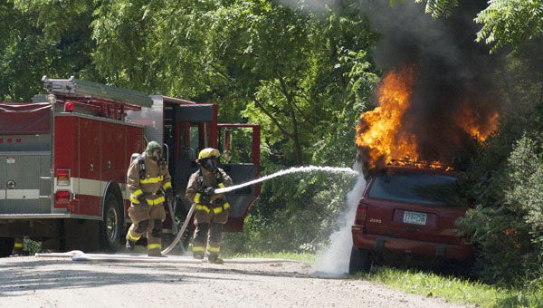 Albert Lea Township firefighters respond to a car fire Friday afternoon on West 11th Street. No one was injured. -- Sarah Stultz/Albert Lea Tribune