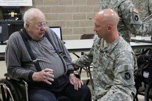 Sgt. 1st Class Jeff Dahlen listens to Neal Petersen talk about his time in the Army Air Force in the 1940s. Petersen was one of a handful of veterans who came from Good Samaritan Society to visit an open house at the Albert Lea Armory on Saturday.