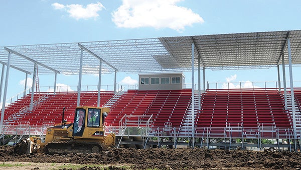 A bulldozer moves ground in front of the grandstand as the new structure nears completion at the Mower County Fairgrounds Tuesday. --Eric Johnson/Albert Lea Tribune
