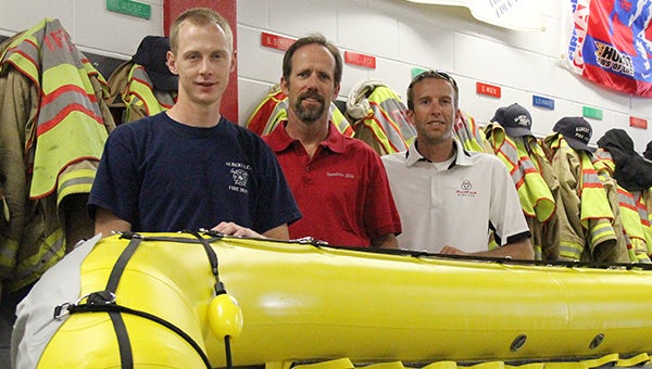Firefighter Brett Boss, left, poses for a photo with Alliance Pipeline technicians Wayne Rankin, middle, and Jared Smith, right. Alliance Pipeline recently gave $5,000 to the Albert Lea Fire Department to allow them to purchase the rescue boat. --Kelli Lageson/Albert Lea Tribune
