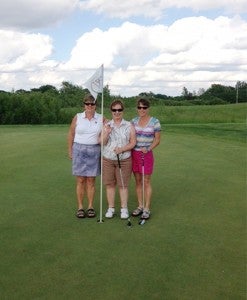 Beth Erickson, middle, hit a hole-in-one on the 17th hole at Wedgewood Cove Golf Club, according to Ryan Thompson, the course’s head golf professional. — Submitted 