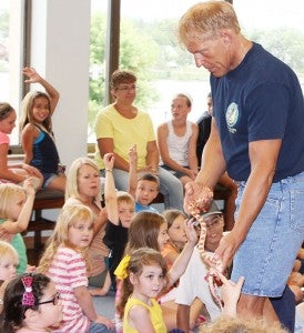 The Zoo Man walks around to let everyone touch a corn snake Thursday at the Albert Lea Public Library. -- Quinn Andersen