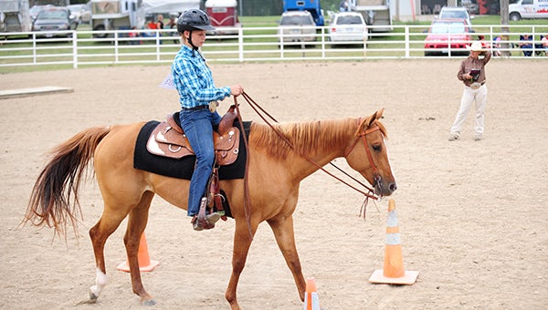 Missy Malakowsky rides her horse Winnie through the trail portion of the horse show on Tuesday at the Freeborn County Fair. Malakowsky will be showing her horse at the Minnesota State Fair in September. --Brandi Hagen/Albert Lea Tribune