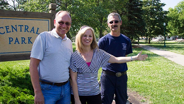 Jenny Nelson with the Albert Lea Inspections Department, center, gestures to Central Park, where the first of three neighborhood picnics is scheduled to take place Thursday evening. Standing beside her are Brad Pirsig with the Utilities Department and Mark Light with the Fire Department. --Sarah Stultz/Albert Lea Tribune