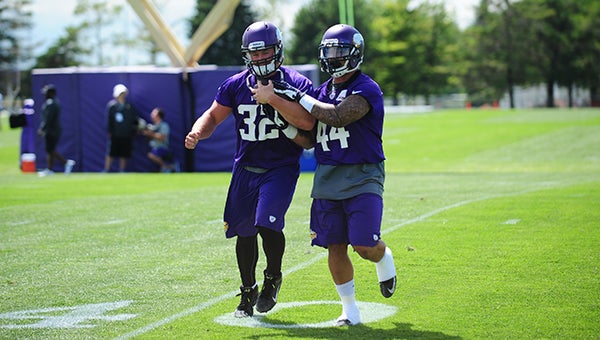 Toby Gerhart, left, protects the ball during a drill as Matt Asiata attempts to make him fumble at the Minnesota Vikings training camp at Minnesota State University in Mankato. — Micah Bader/Albert Lea Tribune