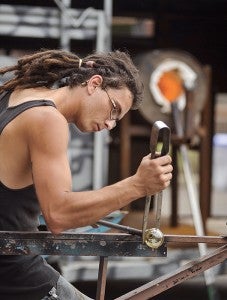Alex Welch demonstrates glass blowing and shaping during the first day of the Austin ArtWorks Festival at the downtown Austin Utilities plant. -- Eric Johnson/Albert Lea Tribune