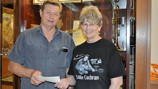 Jerry Monson, left, presents a check for $5,723 to Pat Mulso for the Freeborn County Historical Museum's building fund. The money came from proceeds of the Eddie Cochran Weekend. -- Submitted 