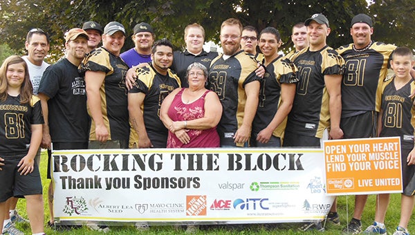 The Albert Lea Grizzlies football team stands Monday with Trudy Donahue, a homeowner at 1807 SE Marshall Ave. The Grizzlies have helped Donahue with upkeep on her property in connection with Rocking the Block, the United Way and Shinefest. — Submitted