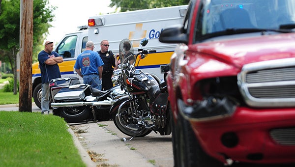 A police officer speaks with witnesses of an crash Saturday between a 2013 Harley-Davidson motorcycle and a Dodge Durango. --Micah Bader/Albert Lea Tribune