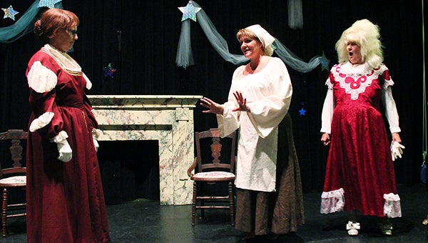 Cinderella, played by Lisa Sturtz, explains to her stepmother, played by Katherine Pacovsky, her desire to go to the ball, while one of the stepsisters, played by Linda Opstad, reacts with surprise.