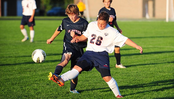 Schafer Overgaard of Albert Lea, a sophomore, battles a St. Peter defender Thursday for possession of the ball in the Tigers’ season opener. St. Peter won 1-0 with a goal in the first half. — Micah Bader/Albert Lea Tribune