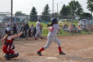 Eesa Lopez watches the ball after swinging at a pitch for the Albert Lea U14 softball team. — Submitted   