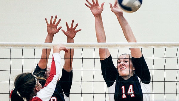 Albert Lea’s Kassi Hardies gets a hand on a spike from Austin’s Kristine Snyder in Game 1 of their match Friday night in Austin. Hardies had two blocks. — Eric Johnson/Albert Lea Tribune