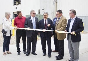 U.S. Sen. Al Franken prepares to cut a ribbon Friday during a ceremony celebrating the expansion of REG Albert Lea. With Franken are REG President and CEO Daniel Oh, REG Vice President Brad Albin, District 27 Sen. Dan Sparks and District 27A House Rep. Shannon Savick.