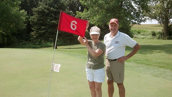 Elaine Long, left, stands with her husband, Dave, after she made a hole-in-one on the sixth hole on Aug. 18 at Oak View Golf Course. The hole is a 128-yard par three. — Submitted