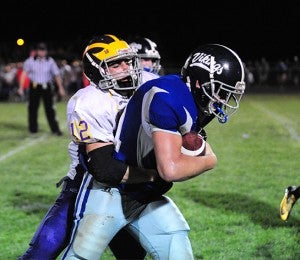 Brandon Brockman of Northwood-Kensett attempts to break free on Friday from Davey Jergens of West Bend-Mallard. Brockman rushed for 10 yards and was second on the team with 12 tackles. Jergens had 11 tackles for the Wolverines. — Micah Bader/Albert Lea Tribune