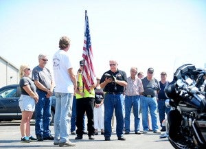 Boyd Uppman, center, reads the Flag Bearer’s Rite to Bryce Haugland, in white, on Monday at Bergdale Harley-Davidson. Watching on left is Barb and Greg Gassen, the parents of Pfc. Jacob Gassen, a soldier from Beaver Dam, Wis. In 2012, the first leg of the tour was dedicated in memory of the fallen Army private.