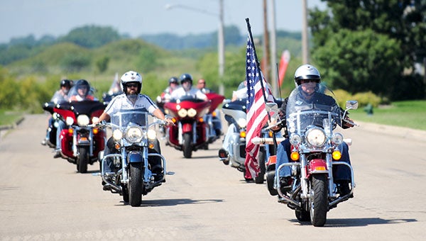 An American flag is escorted to Bergdale Harley-Davidson on Monday by the Wild Prairie Harley Owner’s Group out of Eden Prairie for the 2013 Nation of Patriots Tour. --Brandi Hagen/Albert Lea Tribune