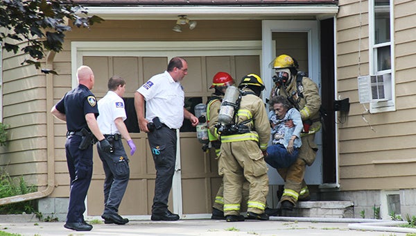 Albert Lea firefighters rescue a 94-year-old woman from a smoke-filled house on Bel Aire Drive in Albert Lea. -- Tim Engstrom/Albert Lea Tribune