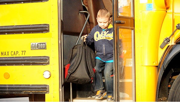 Kale Flugum gets off the bus at Southwest Middle School this morning. Flugum was headed for Sibley Elementary School for the first day of school. --Brandi Hagen/Albert Lea Tribune
