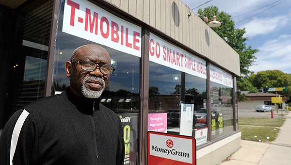 Alioune Ndiaye stands outside his business, The Wireless Center, on West Oakland Avenue in Austin Tuesday morning. Ndiaye drove would-be thieves from his store in the early evening hours of last Friday using a pair of scissors.  --Eric Johnson/Albert Lea Tribune