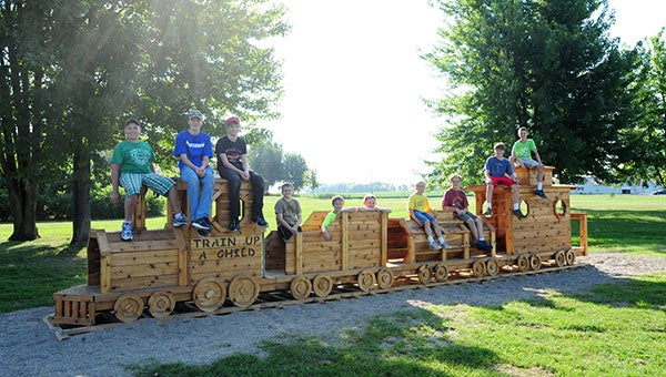 Some of the Cadets from the Hollandale Christian Reformed Church’s boys’ club sit on the train they built during school on Friday. The train was made possible by grant money from Freeborn-Mower Cooperative Services and other donations. The Cadets donated the train to the school as an addition to the playground. --Brandi Hagen/Albert Lea Tribune
