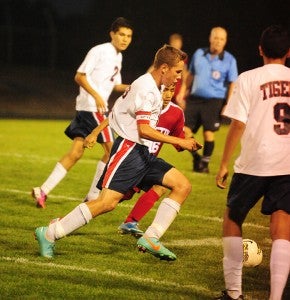 Hunter Tuveson of Albert Lea dribbles the ball up the field Thursday against Austin. The Tigers were able to force overtime with a score late in the first half, but Austin won 3-1. — Micah Bader/Albert Lea Tribune