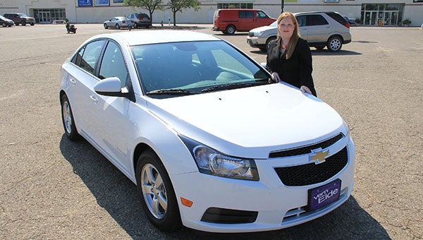 On Friday, Leah McKane stands next to a Chevy Cruze she earned for selling Mary Kay cosmetics and assembling a team of Mary Kay sellers. The car says “Mary Kay” on the door panels. --Tim Engstrom/Albert Lea Tribune