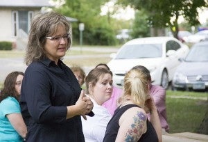 Jill Marin, Albert Lea school board member and wife of Third Ward Councilor George Marin, speaks Tuesday about the loss of her brother at the age of 16 to suicide during a memorial service at Central Park. 