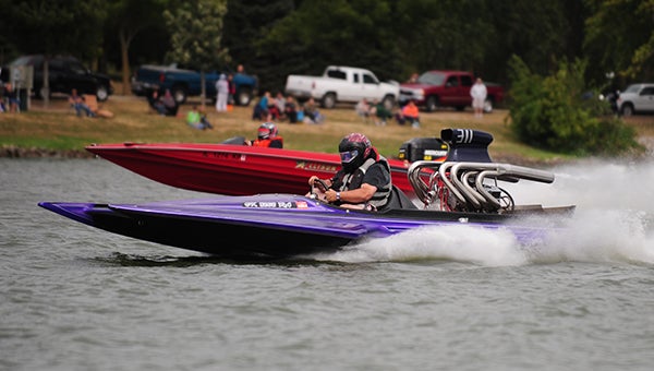Troy McDonald drives his purple v-drive drag boat Saturday during races on Fountain Lake. Dave Hanle trails in his Allison XB2002 drag boat, but he won the Lake Racer 2 category. — Micah Bader/Albert Lea Tribune