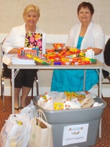 Mary Ellen Johnson, left, and Carol Frydenlund organize school supplies collected by AAUW that will be distributed to local children in need of school supplies for this upcoming school year.