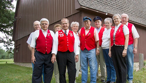 Some of the Sons of Norway Normanna Lodge No. 52 members stand in front of the barn Thursday. From left are Cliff Otterson, Paul Anderson, Le Anderson, Orvin Drangstveit, Lee Bjelland, Dick Bjelland, Orren Olson, Margaret Otterson, Bev Field and Bob Field. The barn sold during a public auction Aug. 27. --Sarah Stultz/Albert Lea Tribune