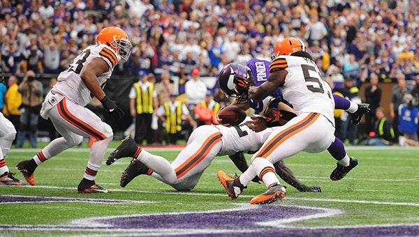 Minnesota Vikings quarterback Christian Ponder dives across the goal line while three Cleveland defenders try to stop him. Ponder rushed for two touchdowns in Minnesota's 31-27 loss. — Drew Claussen