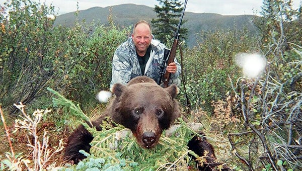 Albert Lea resident Bob Ball poses with a grizzly bear he shot in Alaska in August. -- Submitted