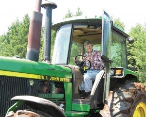 Jennifer Vogt-Erickson’s  mom, Markell Vogt, poses  for a photo in her tractor. -- Submitted