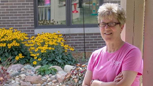 Maribeth Walton poses for a photo in a courtyard at Good Samaritan Society. As director of environmental services, she helped build the courtyard in 2011. --Kelli Lageson/Albert Lea Tribune