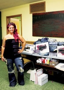 Angel Hogate stands in her work space. Hgoate spends about three hours on each pair of jeans.