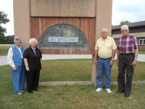 First Baptist Church of Clarks Grove will celebrate its 150th anniversary Oct. 11-13. Pictured are Marvel Beiser, chairman of the historical committee, Kathy Jensen, celebration committee member, Everett Jensen, volunteer, and Elzo Peterson, historical committee member. --Submitted