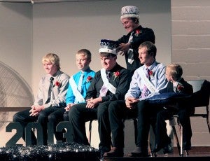 Nick Anderson, the 2012 Homecoming king for Glenville-Emmons High School, crowns the 2013 Homecoming king, Aaron Dempewolf, on Monday night in the high school gym. Candidates for king are pictured from left: Justice Haines, Sam Johnson, Dempewolf and Kenny Koch. --Brandi Hagen/Albert Lea Tribune
