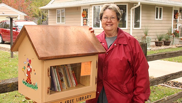 Carol Hegel Lang poses for a photo by the Little Free Library she had built. The library is at her property at 806 Lincoln Ave.  --Kelli Lageson/Albert Lea Tribune