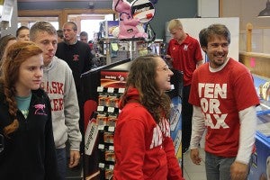 University of Nebraska drum major Nicholas Raimondi, right, a senior from Deerfield, Ill., smiles along with Hannah Fahrlander, a sophomore trumpet player from Omaha, as members of the Nebraska marching band flood Trail's Travel Center shortly after 11 a.m. Friday. Three buses full of band members were on their way to Minneapolis for the football game Saturday between the Cornhuskers and the Minnesota Golden Gophers. -- Tim Engstrom/Albert Lea Tribune