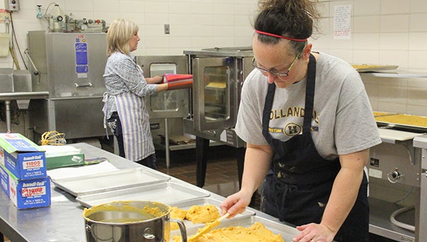 Parents Theresa Blizzard, right, and Lauri Olson prepare dessert bars for the 2013 fall supper at Hollandale Christian School. --Kelli Lageson/Albert Lea Tribune
