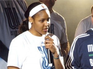 Maya Moore of the Minnesota Lynx speaks into a microphone at the Lynx rally at the Target Center on Oct. 14 after winning the WNBA title. Moore was being interviewed by John Fache. Fache was the sports director at KATE radio before announcing for the Lynx. — Submitted   