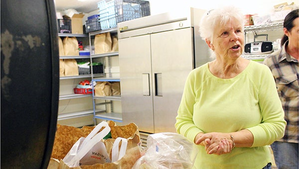 Diane Hill, volunteer for the Albert Lea Salvation Army, loads groceries for a client at the organization’s food shelf on Wednesday.  -- Sarah Stultz/Albert Lea Tribune