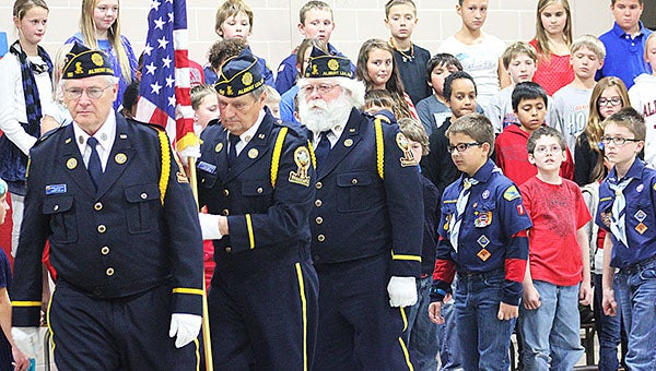 Members of the American Legion Leo Carey Post 56 carry the U.S. flag out of the Lakeview Elementary School gymnasium Monday at the close of a Veterans Day program. --Sarah Stultz/Albert Lea Tribune