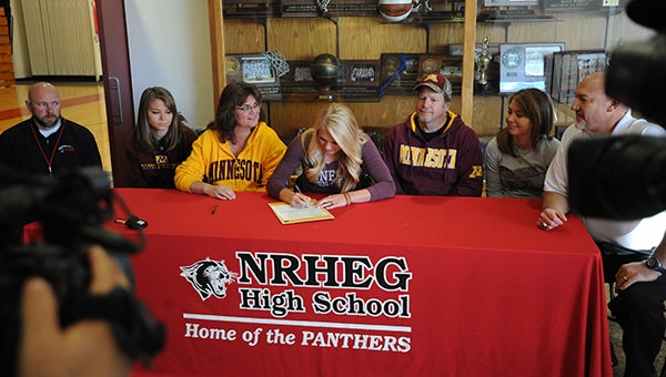 Carlie Wagner of the New Richland-Hartland-Ellendale-Geneva girls' basketball team signed a letter of intent Wednesday morning to play for the University of Minnesota. From the left are NRHEG assistant coach Grant Berg, Maddie Wagner, Jane Wagner (Carlie's mother), Carlie Wagner, Darren Wagner (Carlie's father), Marnie Wagner and NRHEG head coach John Schultz. — Micah Bader/Albert Lea Tribune  