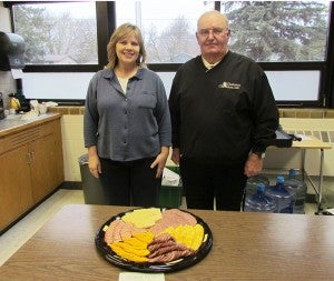 LaVerne Walheim of the Glenville American Legion presented meat and cheese trays from the Glenville and Emmons American Legions to Glenville-Emmons business education teacher Diana Cink this week in recognition of  American Education Week.  A basket of cookies and bars was given to the Glenville-Emmons staff from the Glenville Legion Auxiliary thanking them for their work. -- Submitted